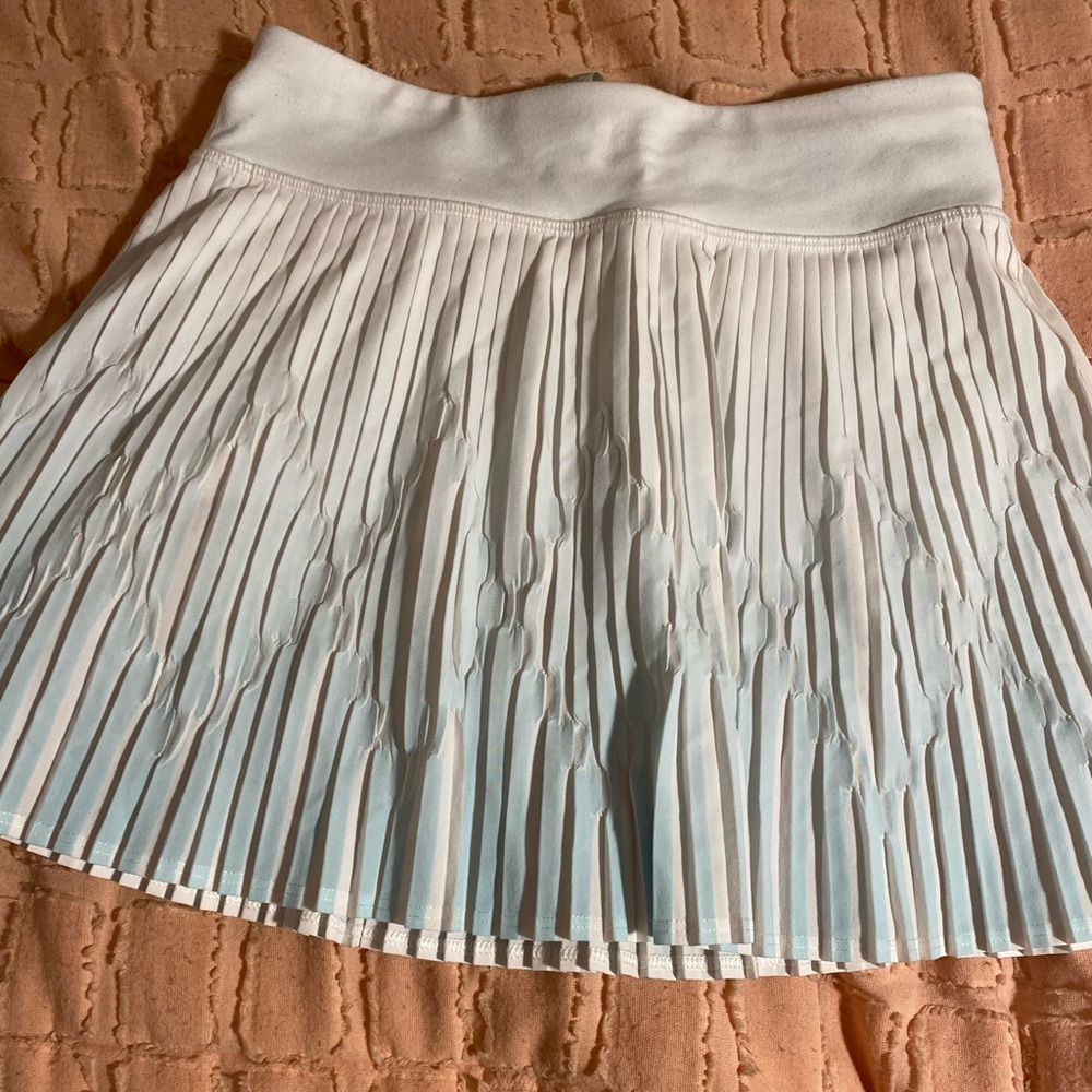 A blue and white size 8 ruffle ivvia skirts with built in shorts.